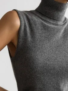 Close-up of a grey knitted sleeveless turtleneck vest showing premium fabric texture.