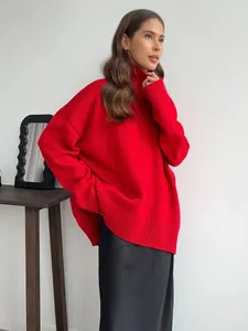 Primo piano del maglione rosso a collo alto oversize da donna con polsini a coste.