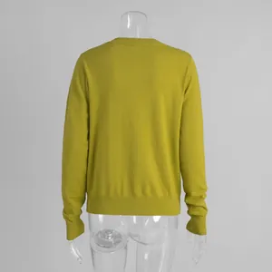 Detailed back view of a yellow mustard knit sweater for women with ribbed cuffs