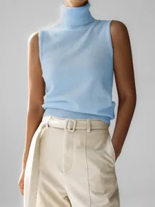 Detailed view of light blue sleeveless turtleneck knitted vest with ribbed hem