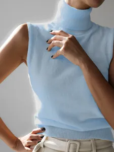 Close-up of light blue sleeveless turtleneck knit vest with refined texture.