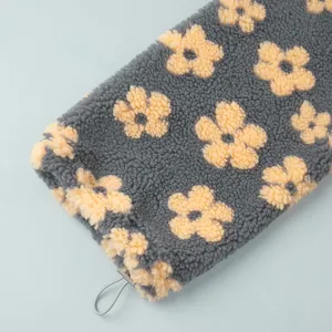 Detail of polar fleece sweatshirt showing fluffy flower pattern and adjustable drawstring.