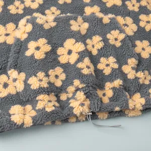 Close-up view of the warm fleece texture and flower pattern on a drawstring hoodie