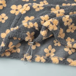Macro detail of warm fleece floral sweatshirt showing the adjustable drawstring hem