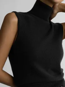 Close-up of black sleeveless turtleneck knitted vest showing soft fabric texture
