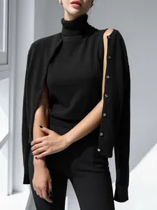 Detailed shot of a minimalist black high-neck knitted sleeveless vest top for women.