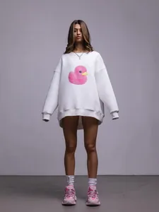 Dettaglio della stampa grafica con papera rosa su felpa bianca oversize di qualità