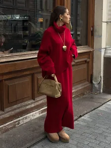Chic red turtleneck knit sweater and maxi skirt two-piece set shown in street style view