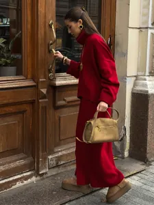 Elegant red turtleneck knit sweater and long skirt set for autumn street style look.