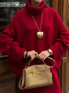 Street style view of a red oversized turtleneck sweater and knit skirt set for women