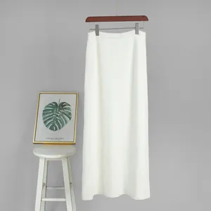 Detailed view of a white knitted long skirt with a high waist design for fall and winter