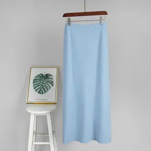 Detail view of a light blue knitted maxi skirt with fine ribbed texture for winter