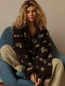 Casual oversized dark brown fleece sweatshirt with yellow floral print and half-zip collar.
