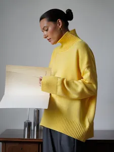 Dettaglio del profilo di un maglione a collo alto giallo brillante a maglia larga