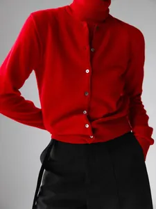 Detailed view of vibrant red knit cardigan and high-neck sleeveless sweater set