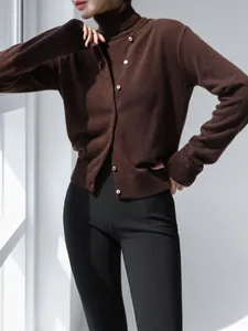 Detail showing the brown turtleneck top and matching cardigan set with knit texture