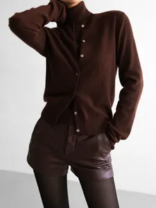 Detail view of brown knitwear set with sleeveless turtleneck and matching cardigan