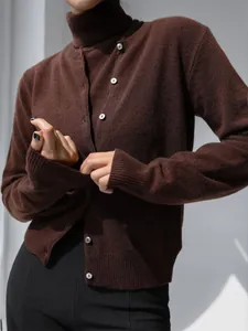 Detailed view of women's brown knit sweater set with mock neck top and button cardigan.