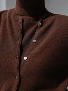 Detailed view of brown knit sweater set featuring shell buttons and soft texture