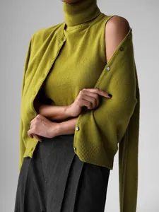 Detailed view of olive green knitwear set with sleeveless turtleneck and cardigan