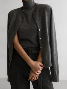 Close-up detail of a charcoal grey knitwear set with high-neck top and buttoned cardigan