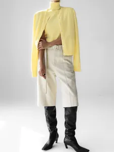 Elegant pale yellow two-piece knit sweater set with sleeveless turtleneck and cardigan