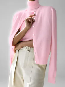 Soft pink two-piece knit sweater set featuring a high-neck top and button-up cardigan