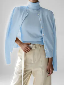 Light blue knit twinset featuring a turtleneck tank top and matching button cardigan