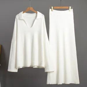 Front view of elegant white two-piece knitted set featuring V-neck sweater and long skirt