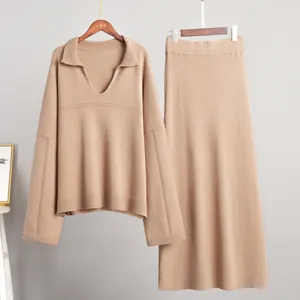 Detailed view of minimalist camel V-neck ribbed knit sweater and maxi skirt matching set