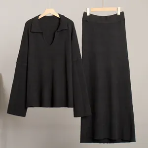 Elegant black two-piece knit set featuring V-neck sweater and matching long maxi skirt