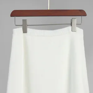 Close-up detail of white knitted skirt waist with ribbed elastic band