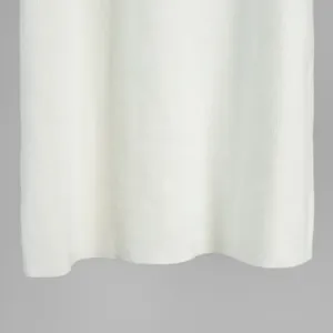 Close-up detail of white knitted fabric showing fine ribbed texture and soft material finish