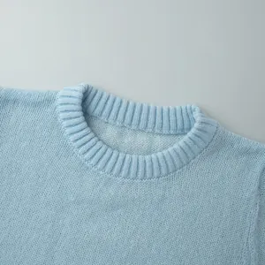 Close-up detail of a light blue mohair knit crew neck sweater with ribbed collar