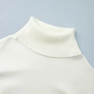 Detailed close-up view of the white ribbed turtleneck collar on a soft knit sweater