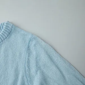 Close-up detail of a light blue semi-transparent mohair knit sweater showing fine texture