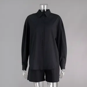 Detailed view of minimalist black cotton long-sleeve shirt and matching shorts set