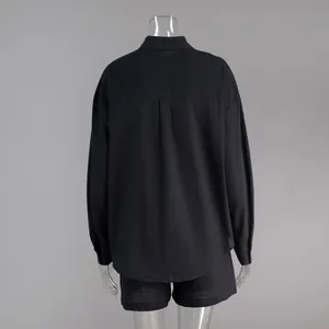 Detailed back view of a minimalist black cotton long-sleeved shirt and shorts set