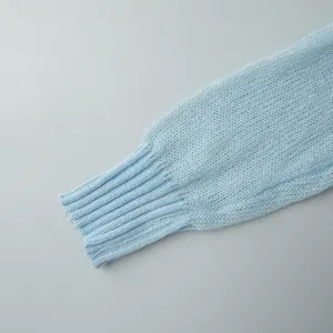 Close-up view of a light blue mohair sweater showing ribbed cuff and fine knit texture