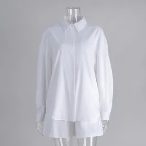 Close-up view of the minimalist white cotton long-sleeve shirt and shorts two-piece set