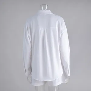 Back view of minimalist white cotton long-sleeve shirt and shorts two-piece set for women