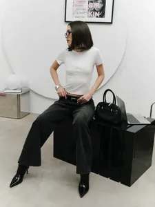 Slim-fit white cropped T-shirt styled in a modern minimalist indoor setting