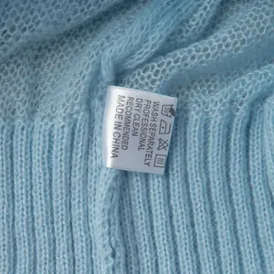 Detail of wash label on a soft light blue mohair knit pullover sweater