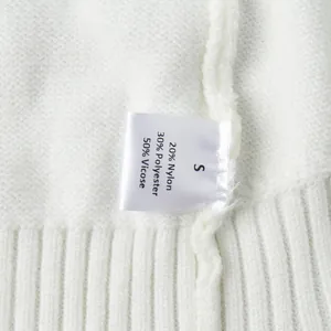 Close-up of white knit sweater care label showing material blend and size S information