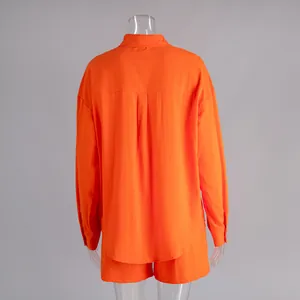 Detailed back view of a vibrant orange pure cotton long-sleeved shirt and matching shorts set