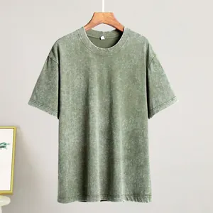 Close-up detail of a vintage acid-washed green T-shirt showing its unique fabric texture