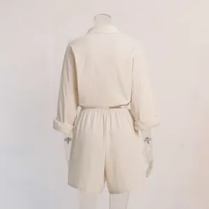 Back view of women's beige linen-blend loose shirt and shorts two-piece vacation set