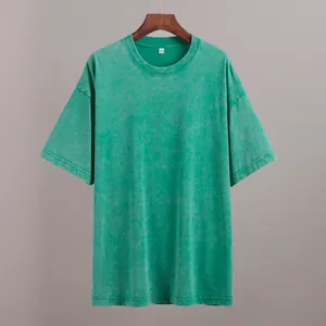 Close-up view of a vintage washed green cotton T-shirt showing distressed texture.