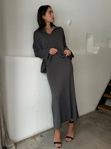 Elegant minimalist charcoal grey knitted V-neck sweater and ribbed skirt set detail