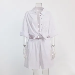 Detailed view of white summer vacation set with tie-front shirt and shorts